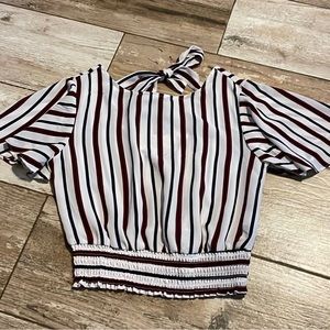 Small red, navy and white shirt that ties in the back.